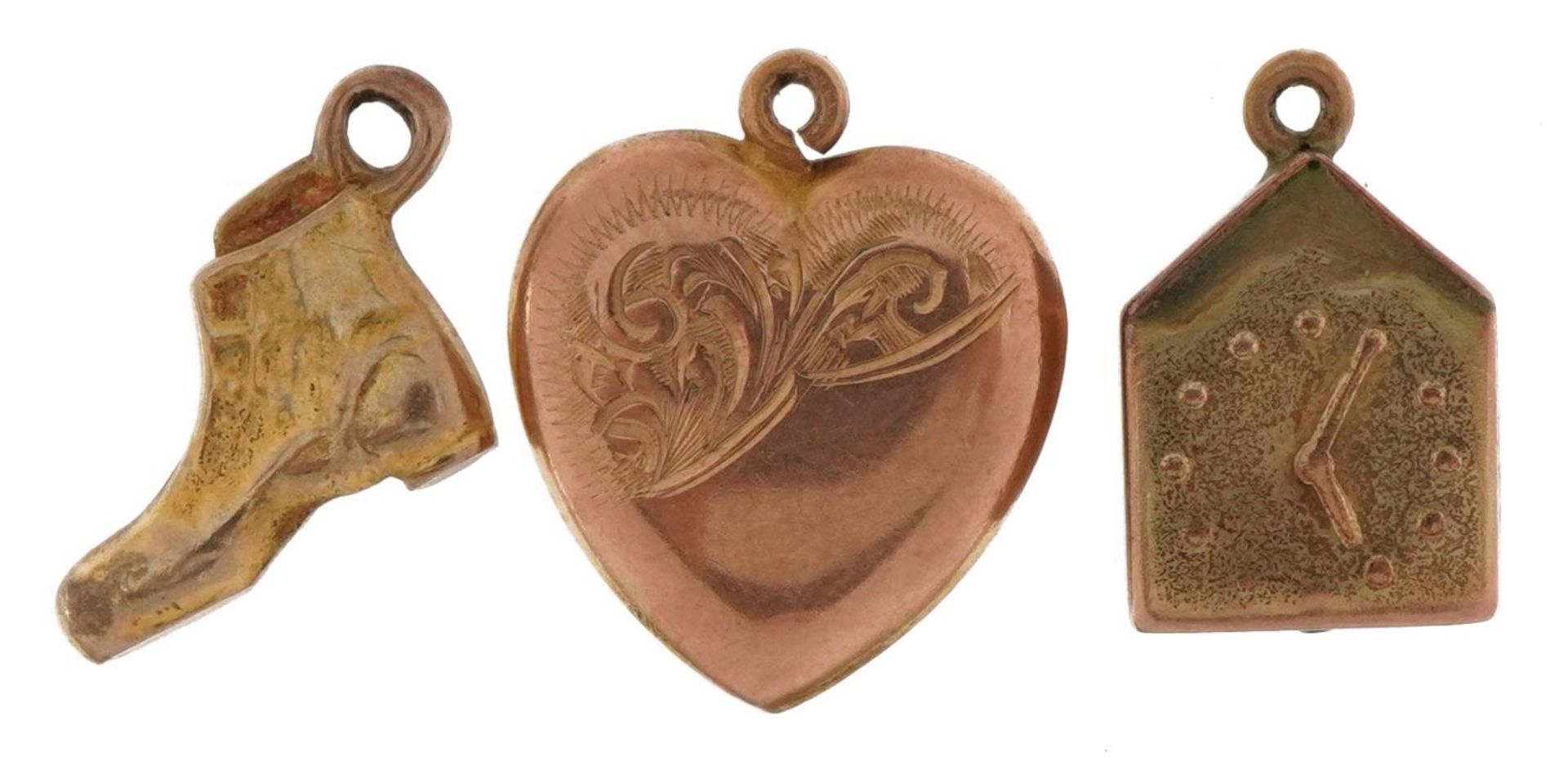 Three 9ct gold charms comprising love heart, boot and clock, the largest 1.6cm high, total 3.0g