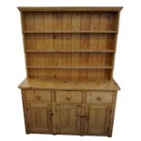 Large Victorian pine farmhouse dresser with open plate rack above three drawers and three cupboard