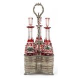 19th century silver plated three bottle tantalus housing three Bohemian ruby flashed cut glass