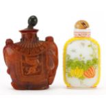 Chinese Peking glass snuff bottle and an amber coloured example in the form of an elephant,