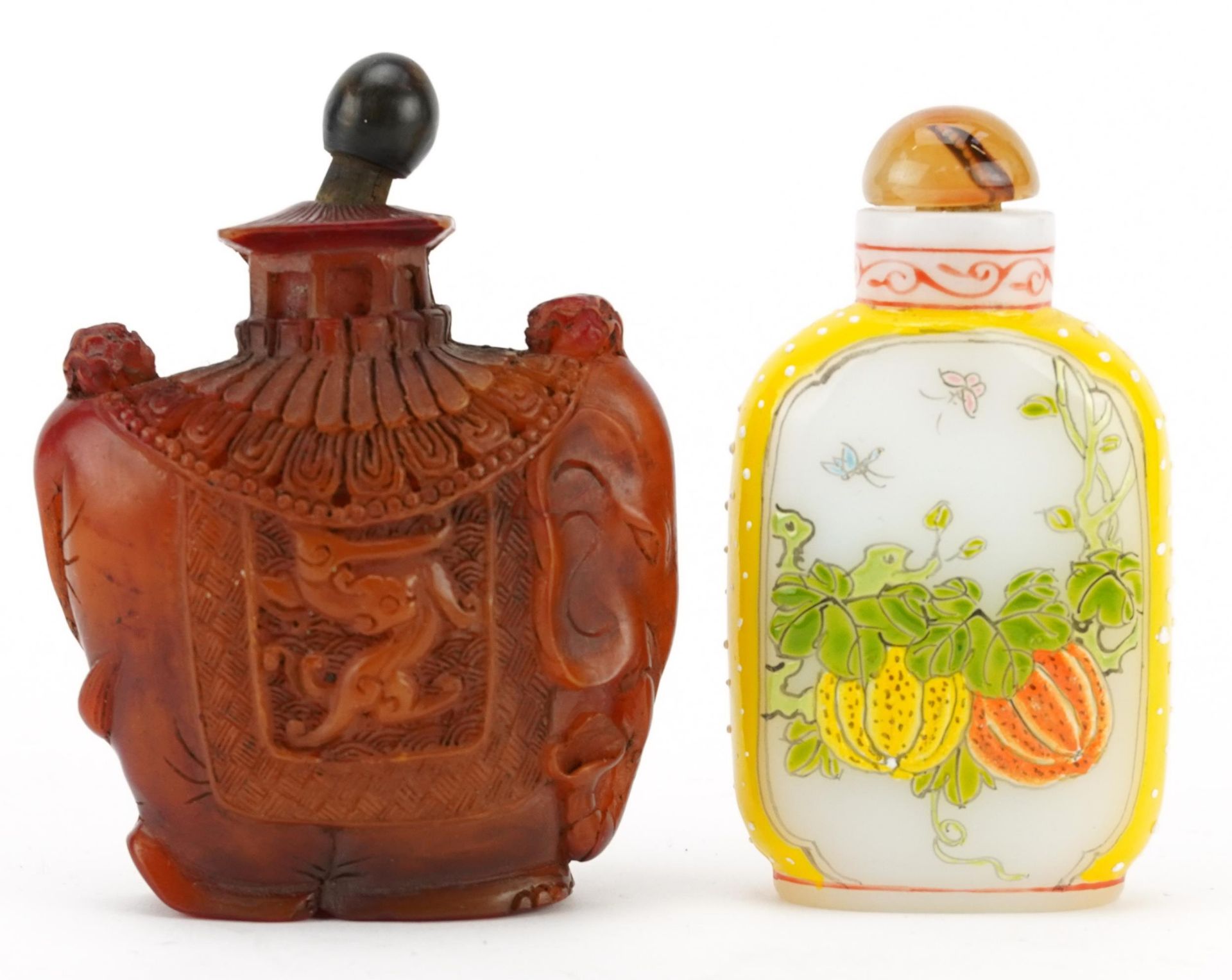 Chinese Peking glass snuff bottle and an amber coloured example in the form of an elephant,