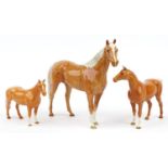 Three graduated Beswick tan horses, the largest 35cm in length