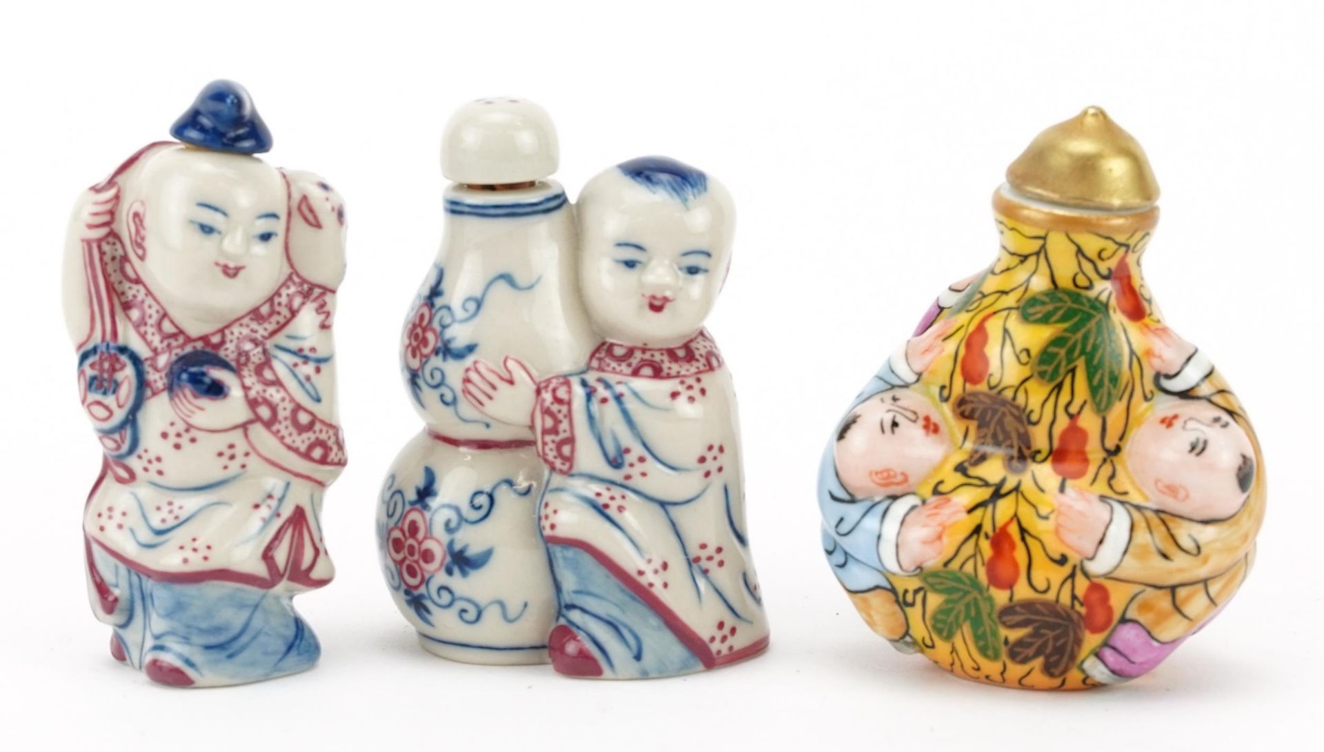 Three Chinese porcelain figural snuff bottles including one hand painted with leaves, the largest