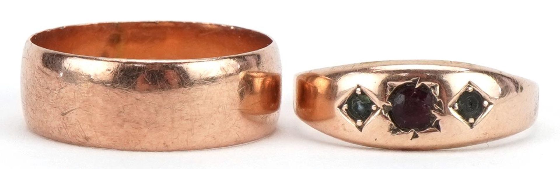 Two Victorian and later 9ct rose gold rings comprising wedding band and Gypsy ring set with a red