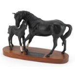 Beswick Connoisseur model of Black Beauty and foal raised on a wooden plinth base, 29.5cm in length