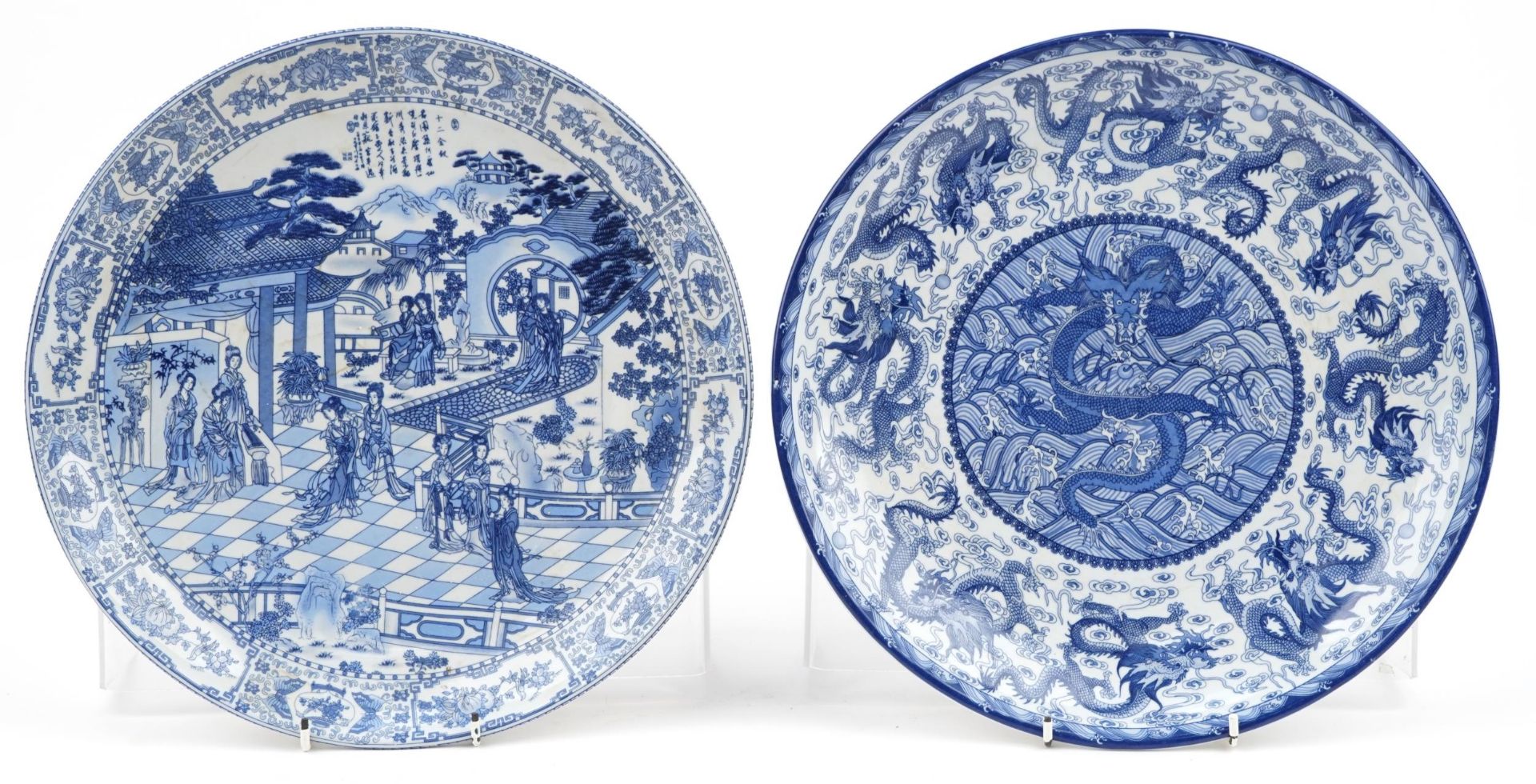 Pair of Chinese blue and white porcelain chargers decorated with figures in a palace setting and