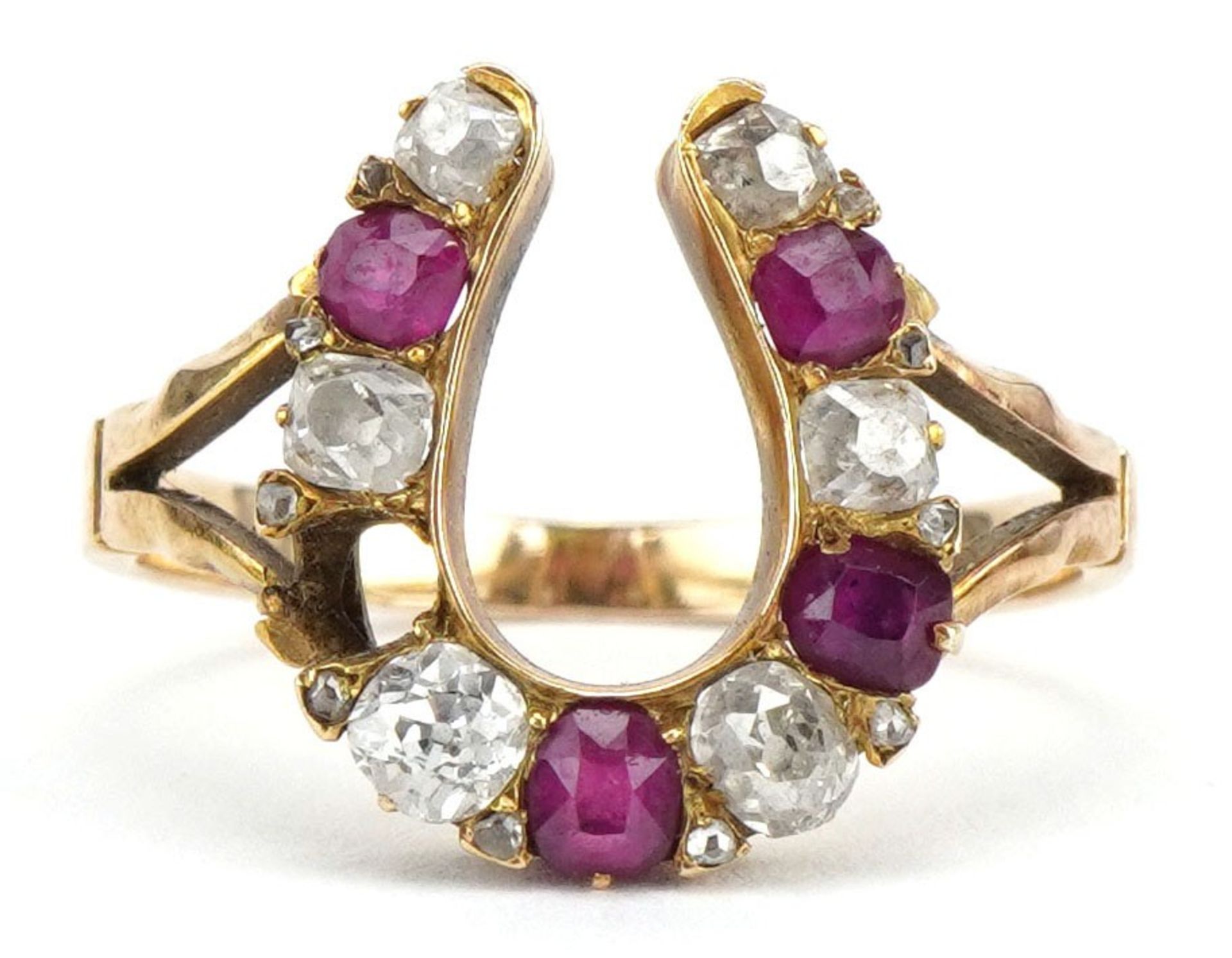19th century unmarked gold diamond and ruby horseshoe ring, tests as 18ct gold, the largest