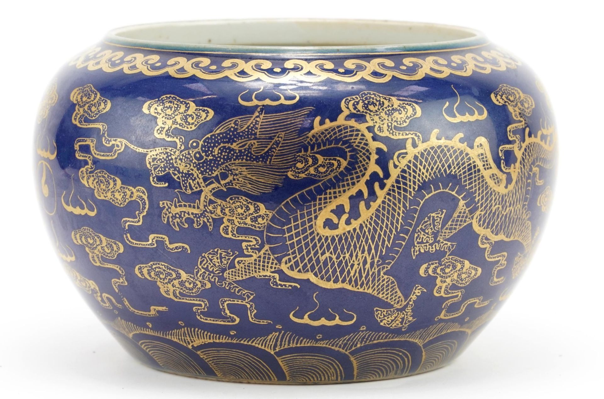 Chinese porcelain powder blue ground jardiniere gilded with dragons chasing the flaming pearl