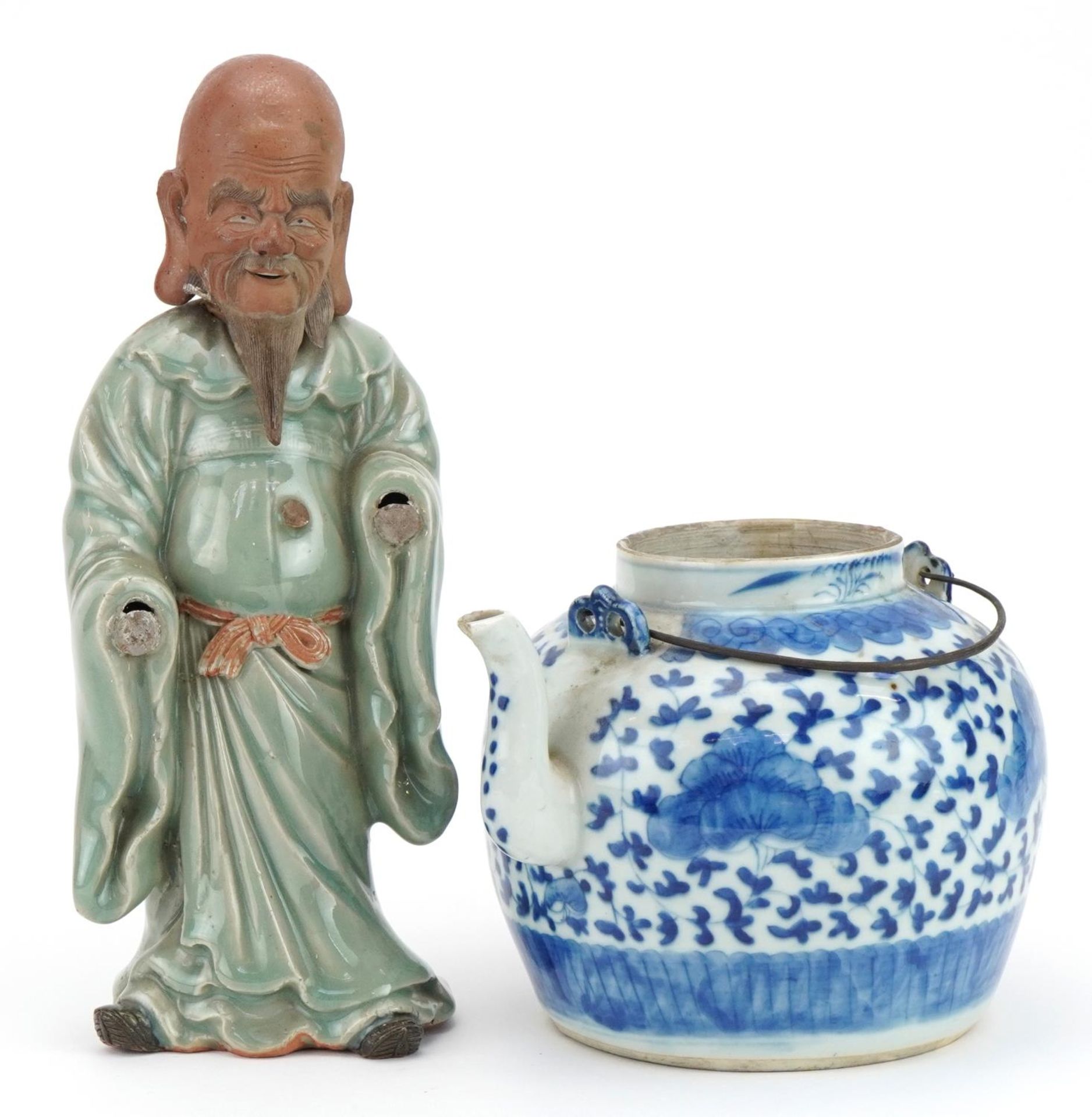 Chinese blue and white porcelain teapot and a celadon glazed figure, the largest 30cm high
