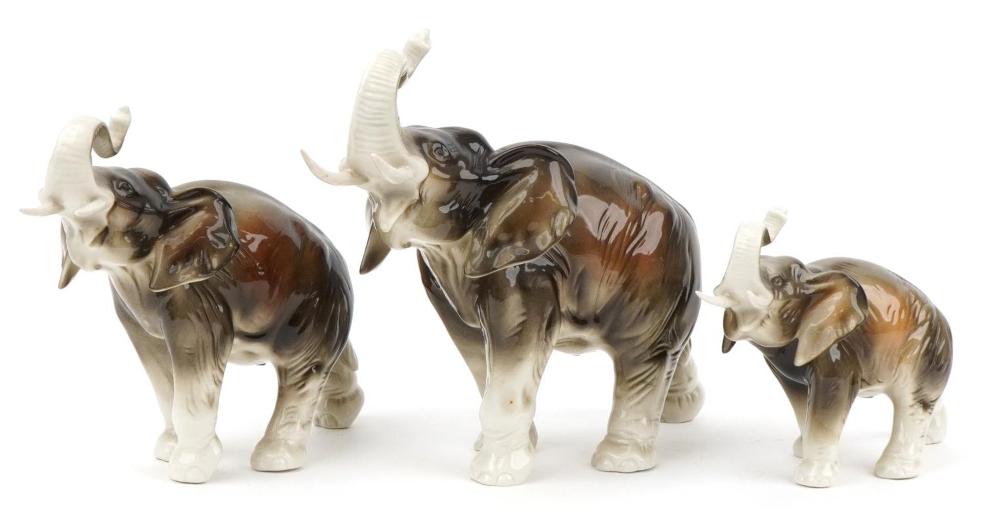 Royal Dux, graduated set of three Art Nouveau Czechoslovakian elephants, the largest 30cm in length
