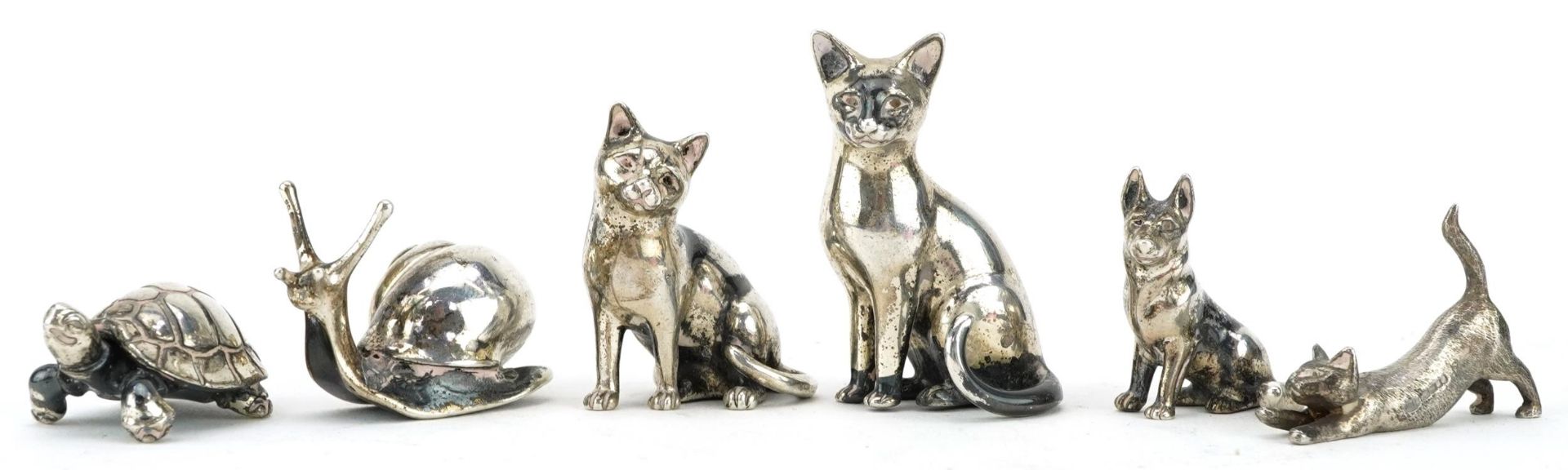 Six miniature silver animals comprising three cats, tortoise, snail and dog, the largest 4cm high,