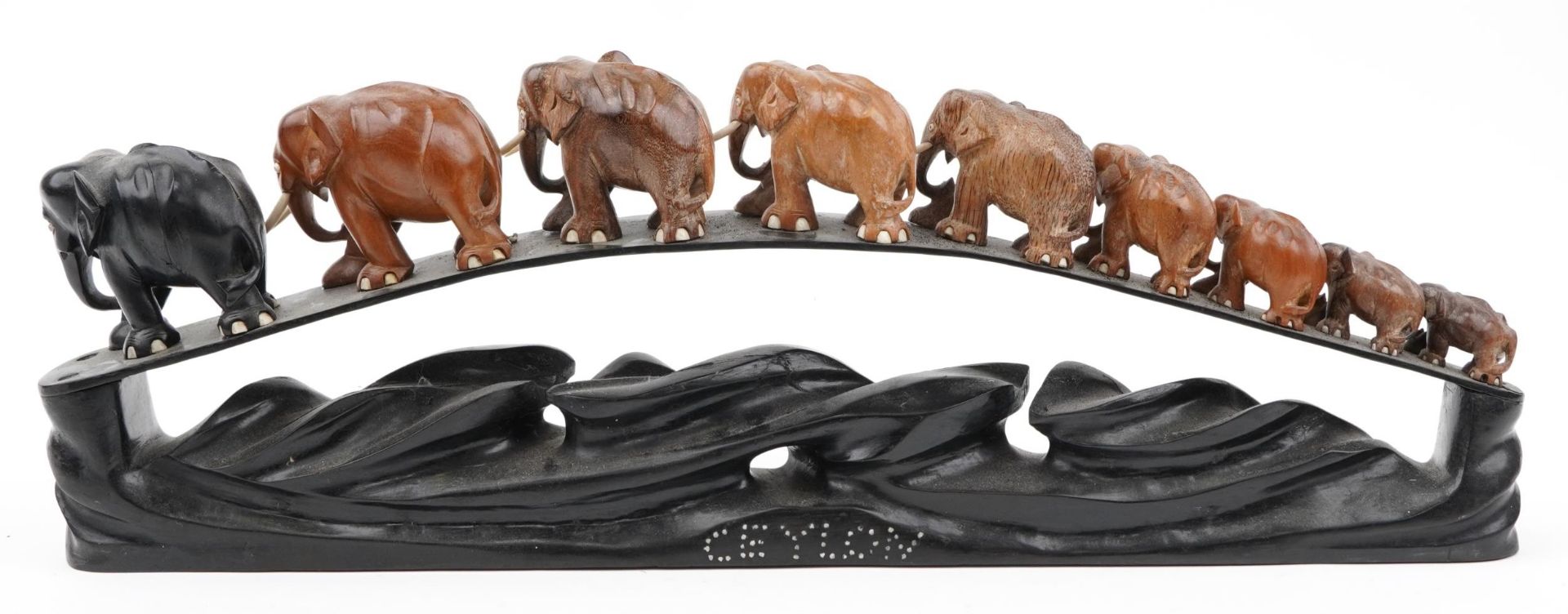 African ebony stand surmounted with nine graduated hardwood elephants, the stand inlaid Ceylon, 78cm - Image 5 of 8