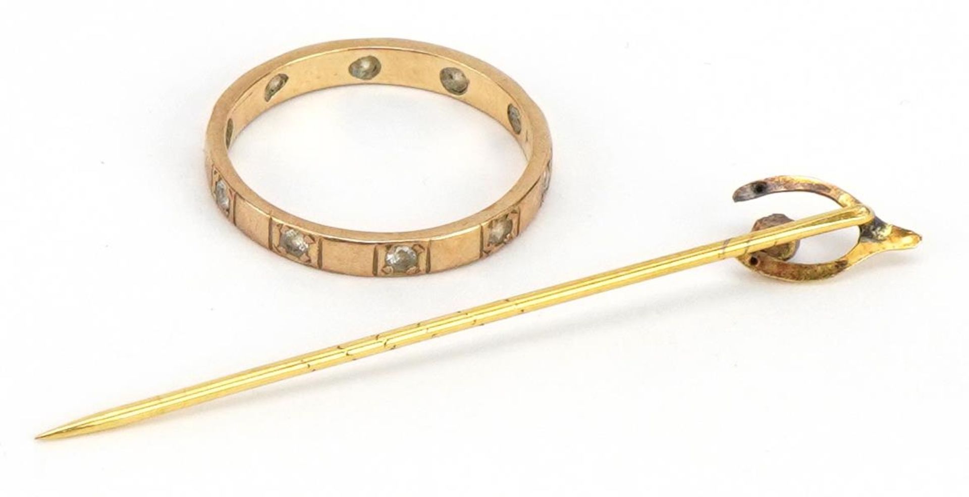 9ct gold clear stone eternity ring and an unmarked gold wishbone stickpin set with a red stone, - Image 3 of 4