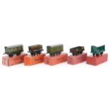 Five Hornby O gauge tinplate model railway wagons with boxes comprising passenger coach guards