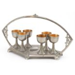 Manner of WMF, German Art Nouveau pewter egg cup stand with six eggcups, 31cm wide