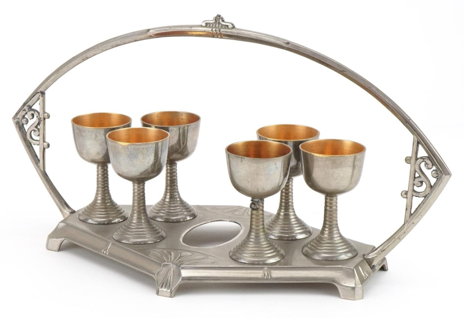 Manner of WMF, German Art Nouveau pewter egg cup stand with six eggcups, 31cm wide