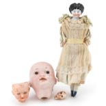 Antique porcelain costume doll and three German bisque doll's heads including Armand Marseille,