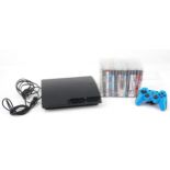 Sony PlayStation 3 games console with controller and a collection of games