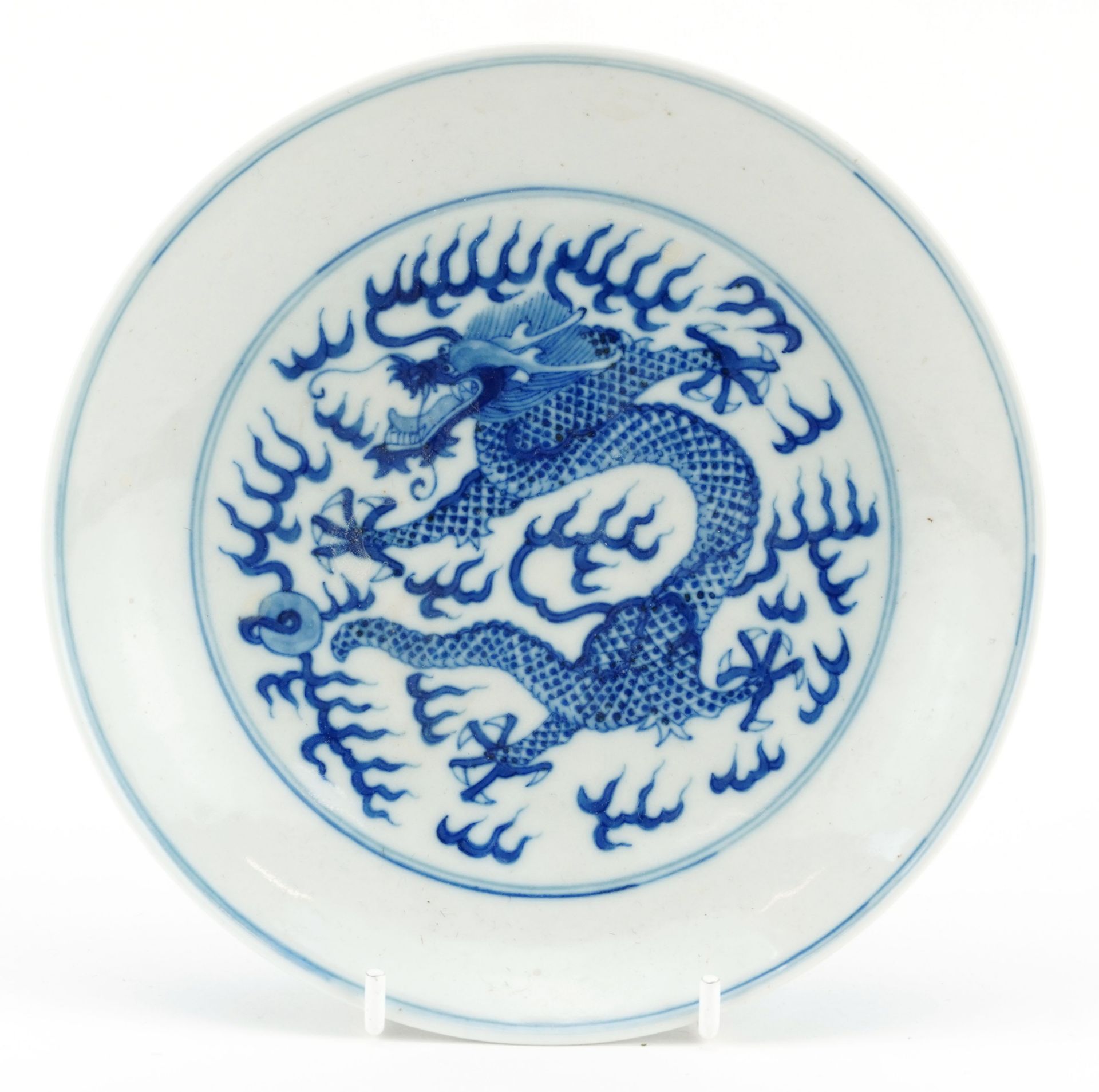 Chinese blue and white porcelain plate hand painted with dragons chasing the flaming pearl amongst