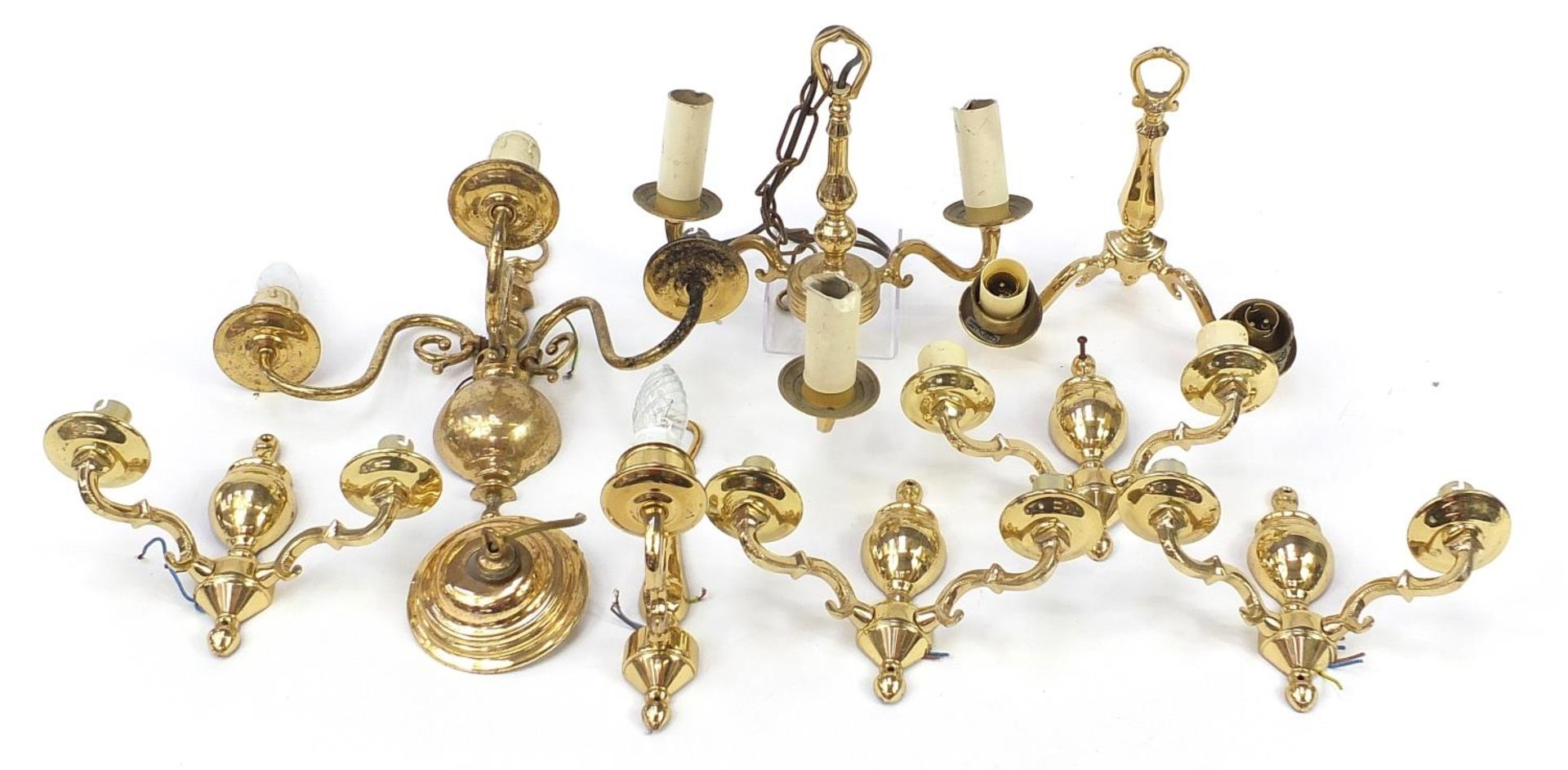 Seven brass wall sconces including a set of four and a three branch chandelier, the largest 30cm