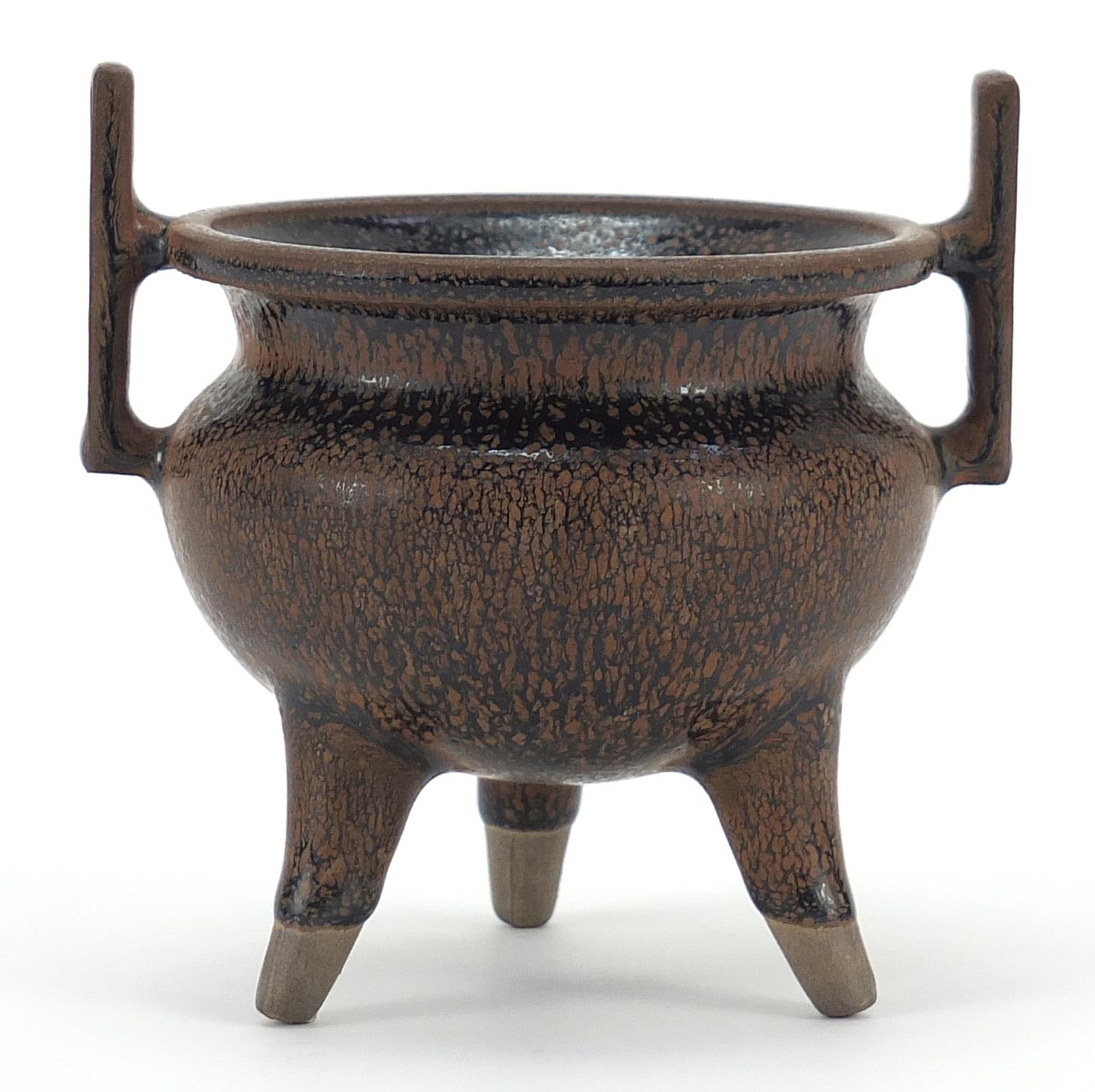 Chinese porcelain tripod censer with twin handles having a hare's fur type glaze, 10cm high