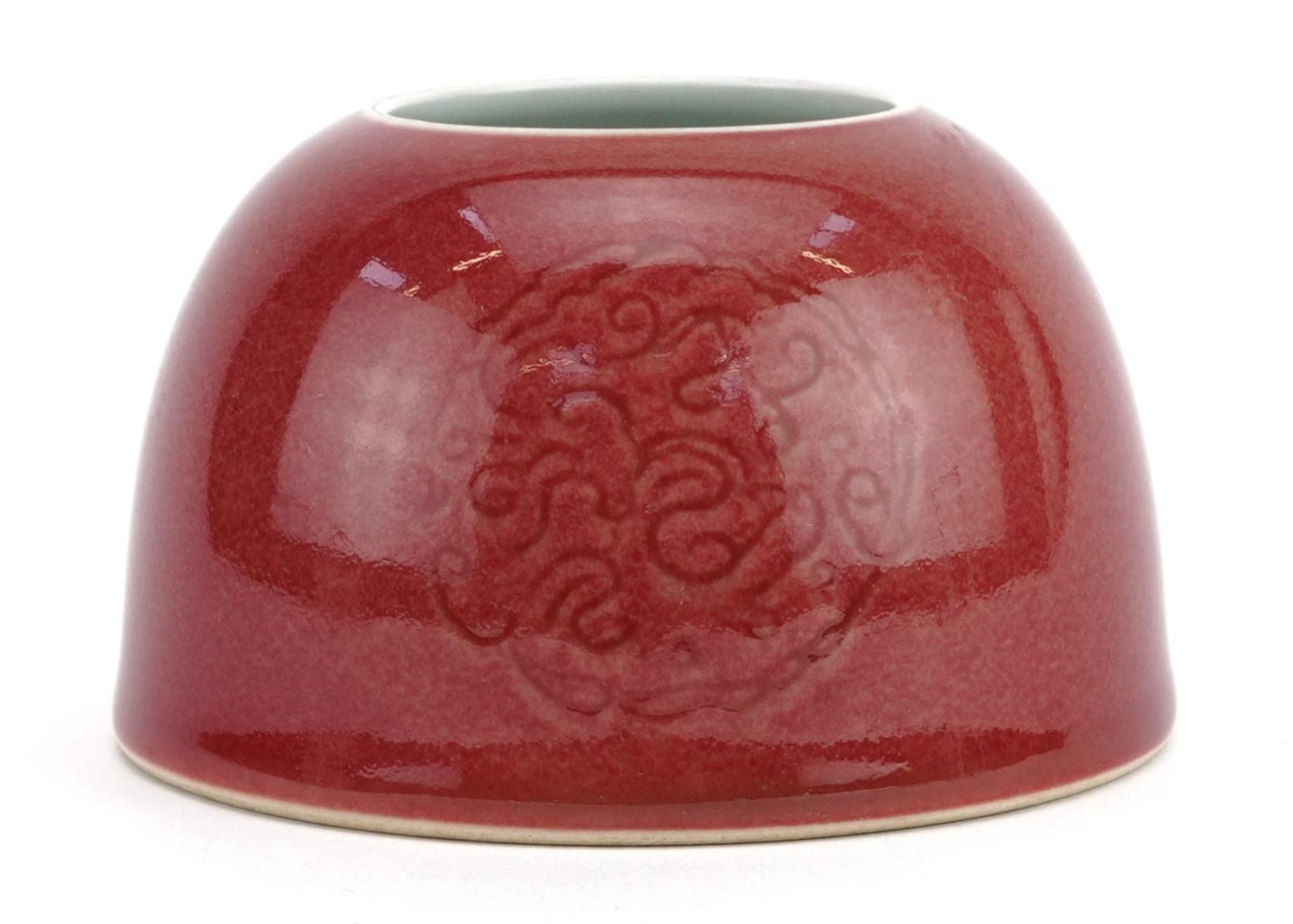 Chinese porcelain beehive water pot having a sang de boeuf glaze decorated with stylised roundels,