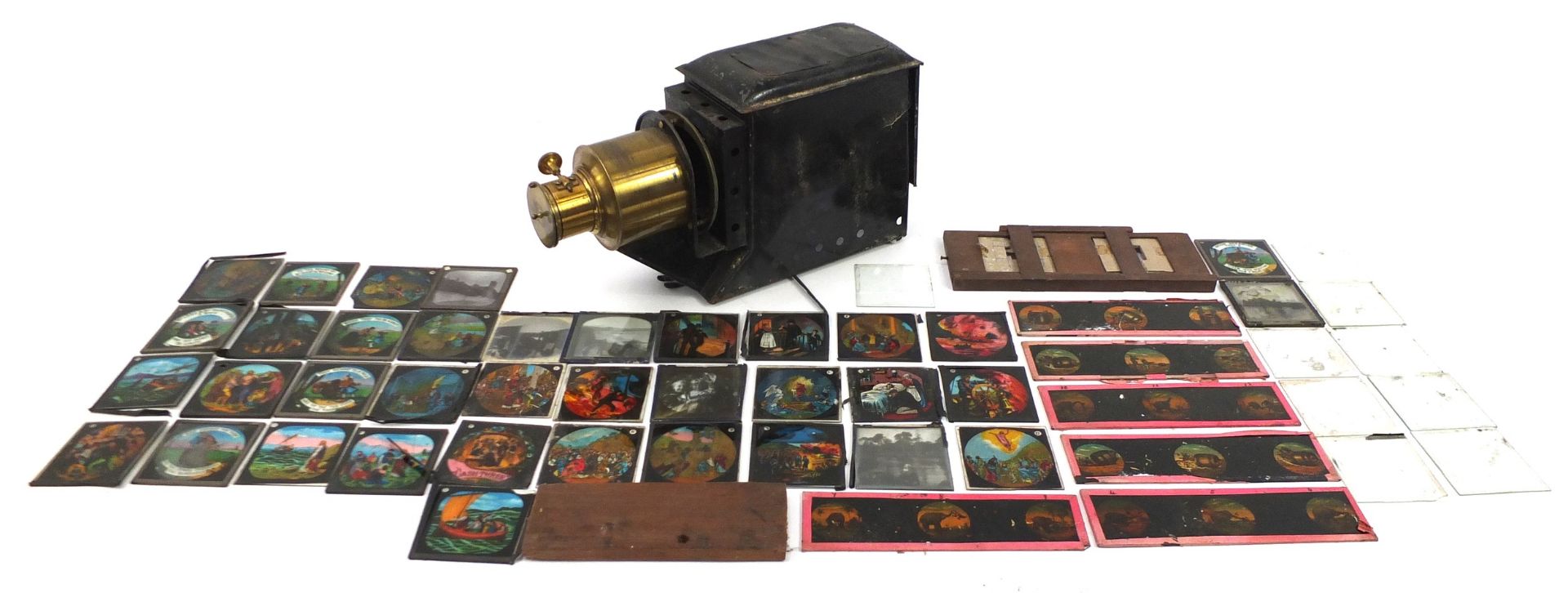 Vintage magic lantern with a collection of glass slides, some coloured, the lantern 40cm in length