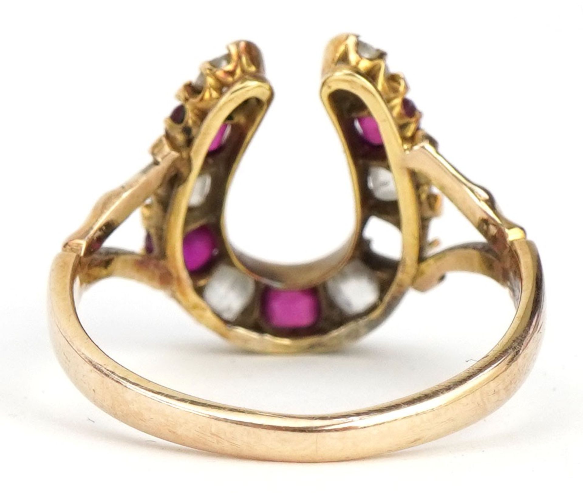 19th century unmarked gold diamond and ruby horseshoe ring, tests as 18ct gold, the largest - Image 2 of 3
