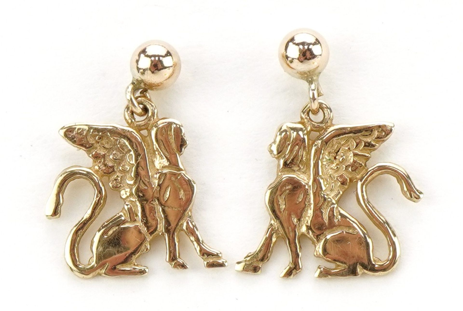 Pair of 9ct gold mythical animal earrings, possibly a griffin, 1.4cm high, 1.4g