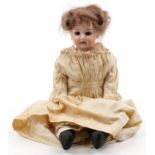 Antique German bisque headed doll with open close eyes, impressed marks to the neck, 38cm high