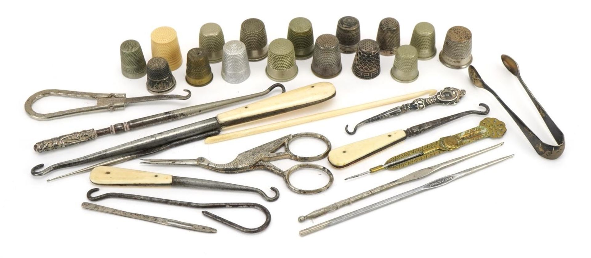 Victorian and later sewing objects including silver thimbles, bone handled button hooks and
