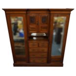 Edwardian satinwood compactum wardrobe with two bevelled glass mirrored doors, two central