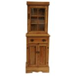 Slim pine dresser with glazed door above drawer and pair of cupboard doors, 183cm H x 61cm W x 38.