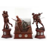 Three bronzed commemorative military figures raised on wooden bases set with coins and medallions by