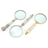 Three large magnifying glasses including two with mother of pearl handles, the largest 25.5cm in