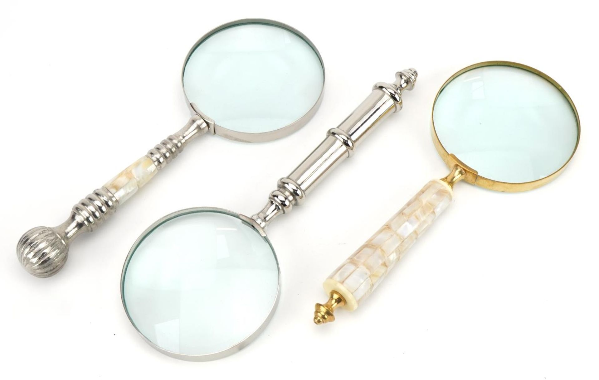 Three large magnifying glasses including two with mother of pearl handles, the largest 25.5cm in