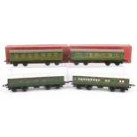 Four Hornby O gauge tinplate model railway passenger coaches, two with boxes