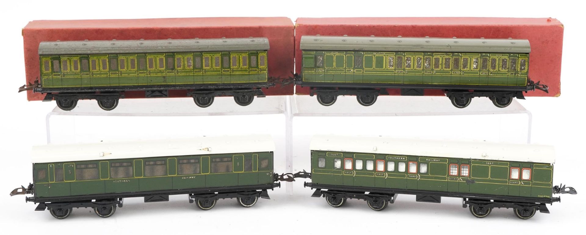 Four Hornby O gauge tinplate model railway passenger coaches, two with boxes