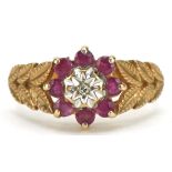 9ct gold ruby and diamond flower head ring with naturalistic shoulders, size K/L, 2.8g