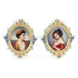 Pair of continental oval porcelain plaques hand painted with maidens housed in floral encrusted