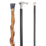 Three wooden walking sticks including an ebony example with silver pommel, the largest 89cm in