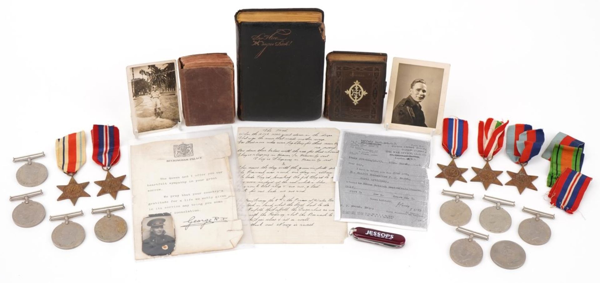 Collection of British military World War II medals and three prayer books