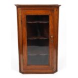 Antique oak wall hanging corner cabinet with glazed door enclosing three shelves, 113cm H x 70cm W x