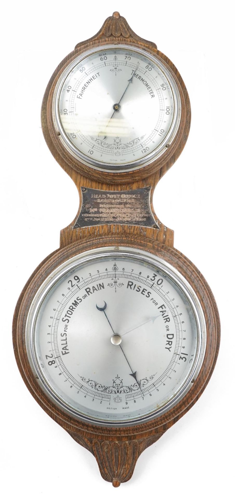 Mid 20th century oak wall barometer with thermometer having silvered dials and white metal plaque
