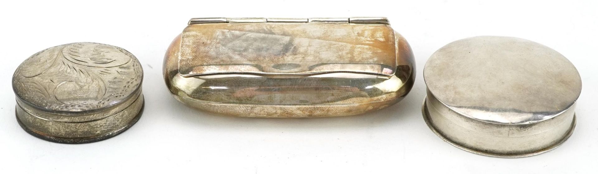 Two circular silver pillboxes and a silver snuff box, the largest 6.5cm wide, total 58.2g