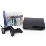 Sony PlayStation 3 games console with controllers and collection of games