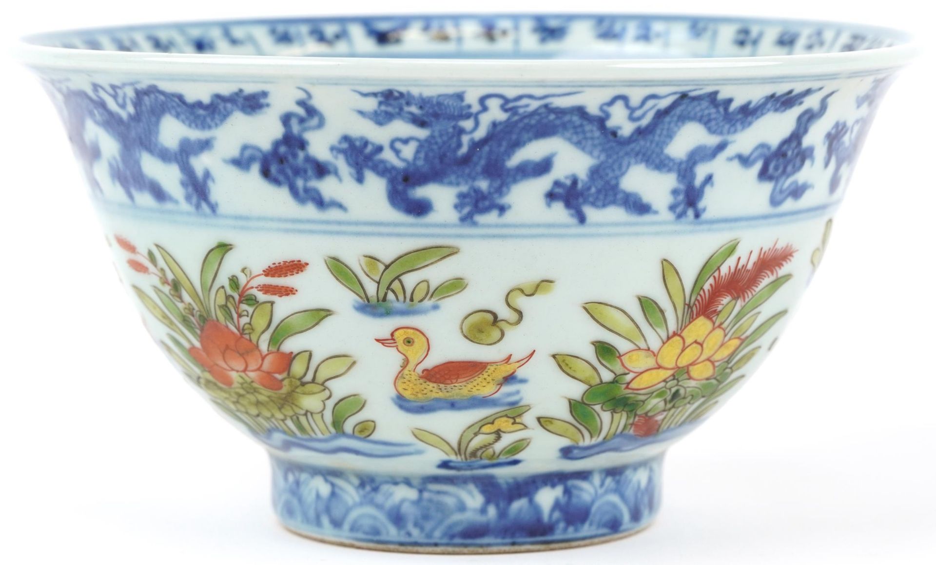 Chinese doucai porcelain bowl hand painted with ducklings in water amongst flowers, six figure