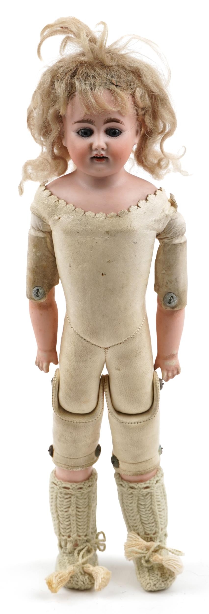 Antique bisque headed and leather fashion doll with open close eyes and articulated limbs,