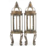 Pair of partially gilt and glazed lantern design candle holders, 82cm high