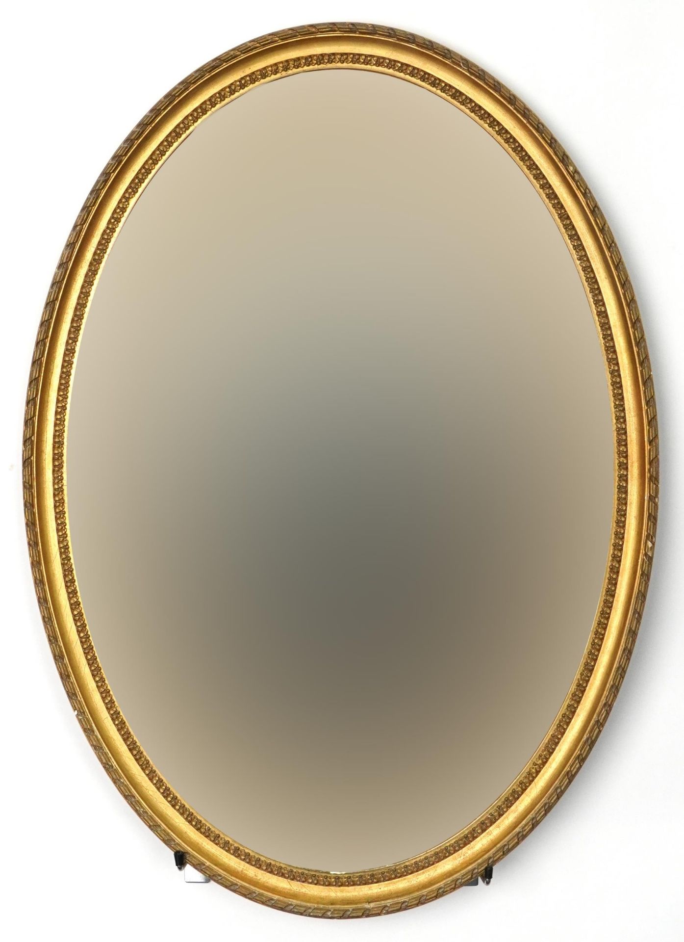 Oval gilt framed wall hanging mirror with bevelled glass, 85cm x 60cm